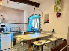 For sale Two-level village house with storage room and land in the characteristic medieval hamlet of
