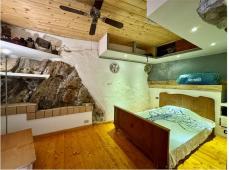 For sale Two-level village house with storage room and land in the characteristic medieval hamlet of